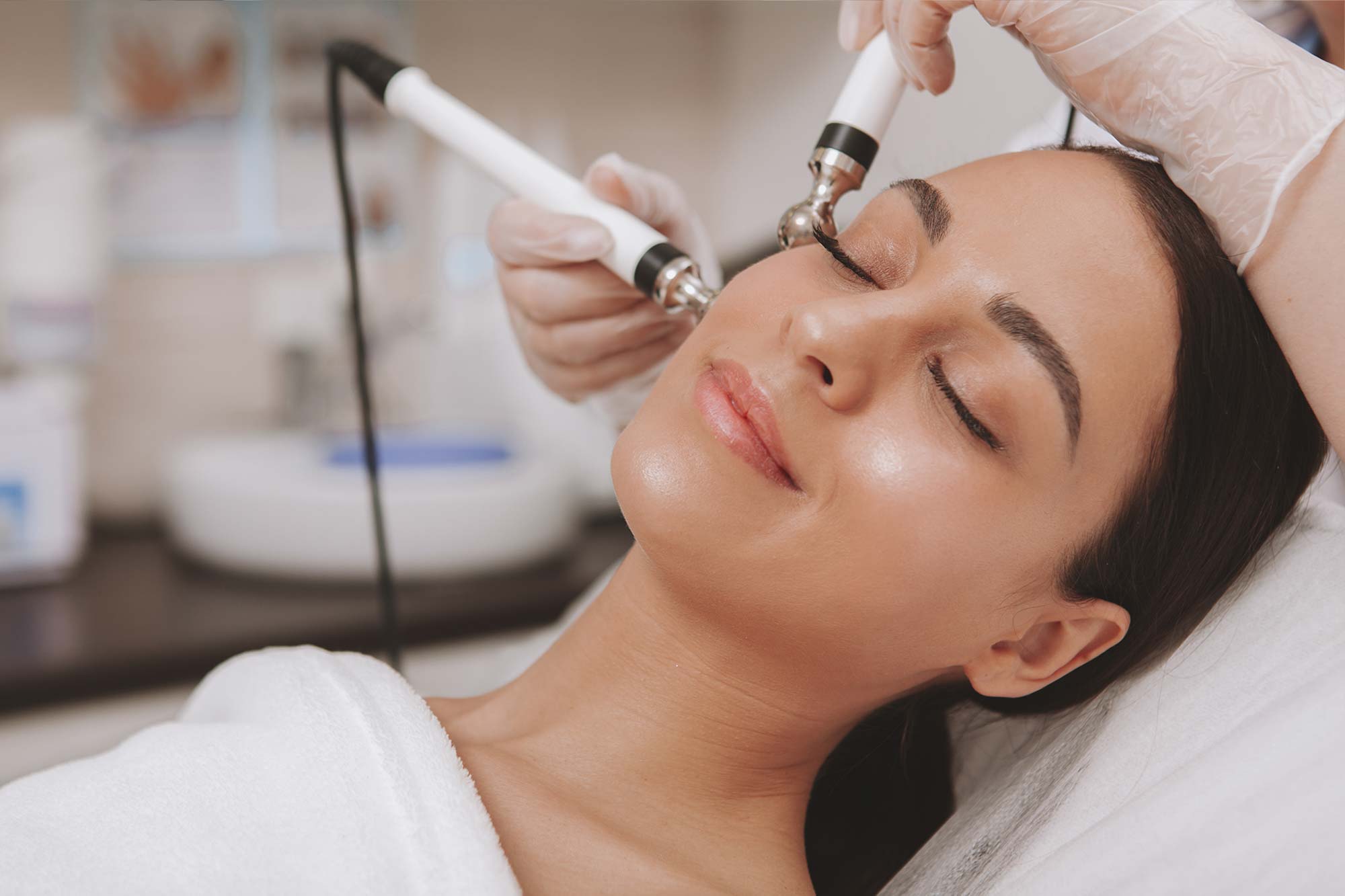 Woman getting microdermabrasion done on her face