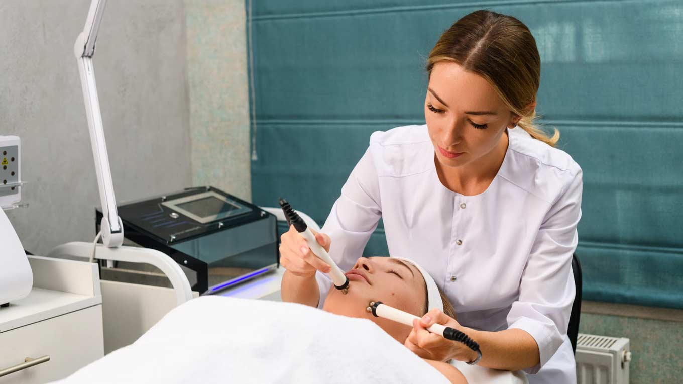 Esthetician performing microdermabrasion procedure