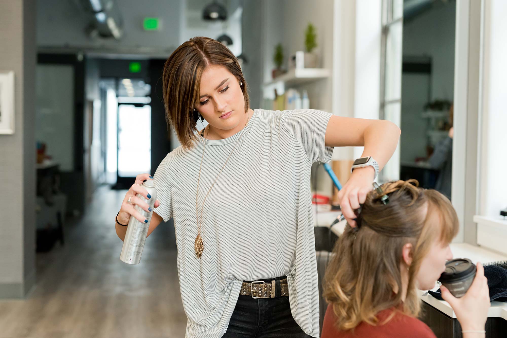 picture of a hair stylist styling woman's hair