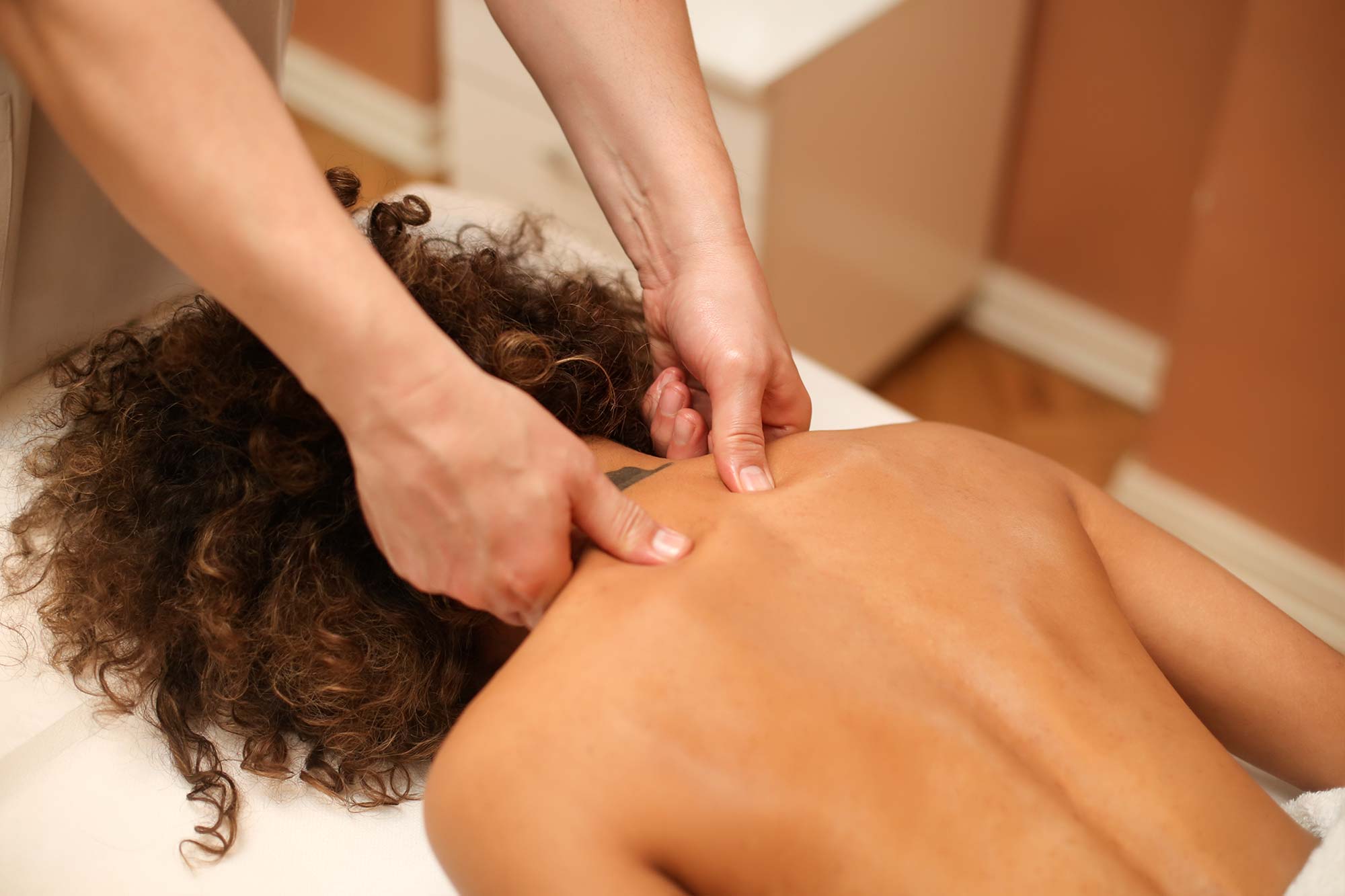 Person massaging woman's shoulders