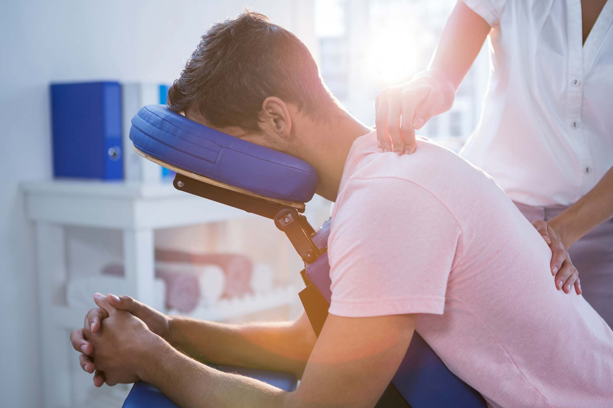 Person massaging man's back