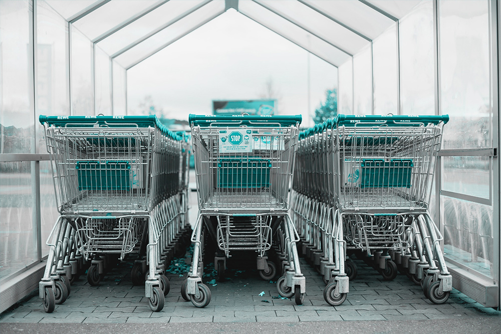 Grocery carts are lined up and ready for consumers to buy products that are insured with consumer product liability insurance.
