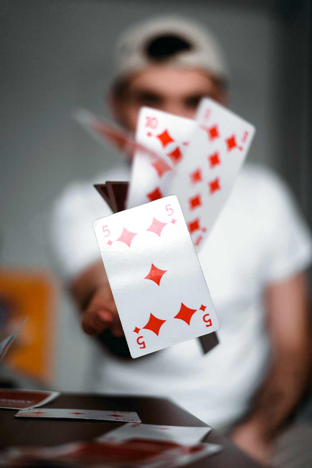 Magician flipping cards towards camera