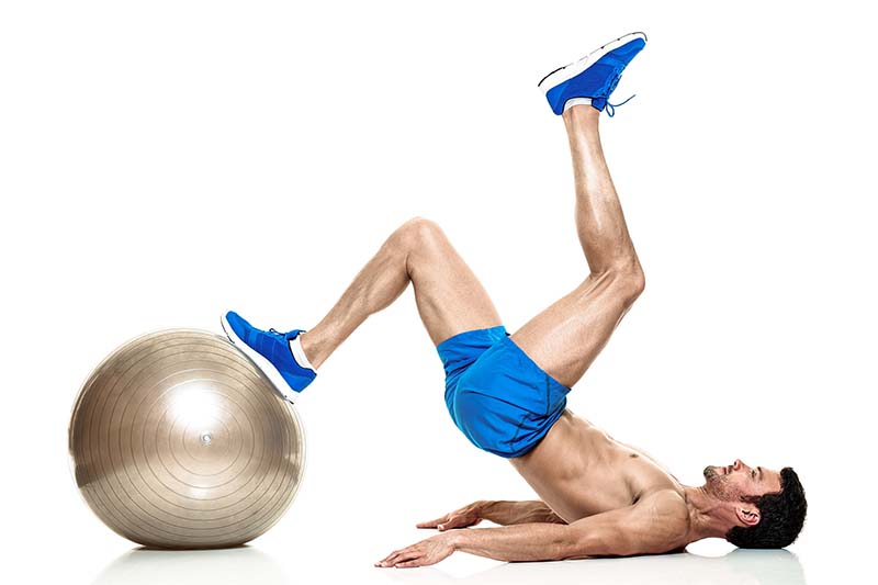 a personal trainer working out on an exercise ball
