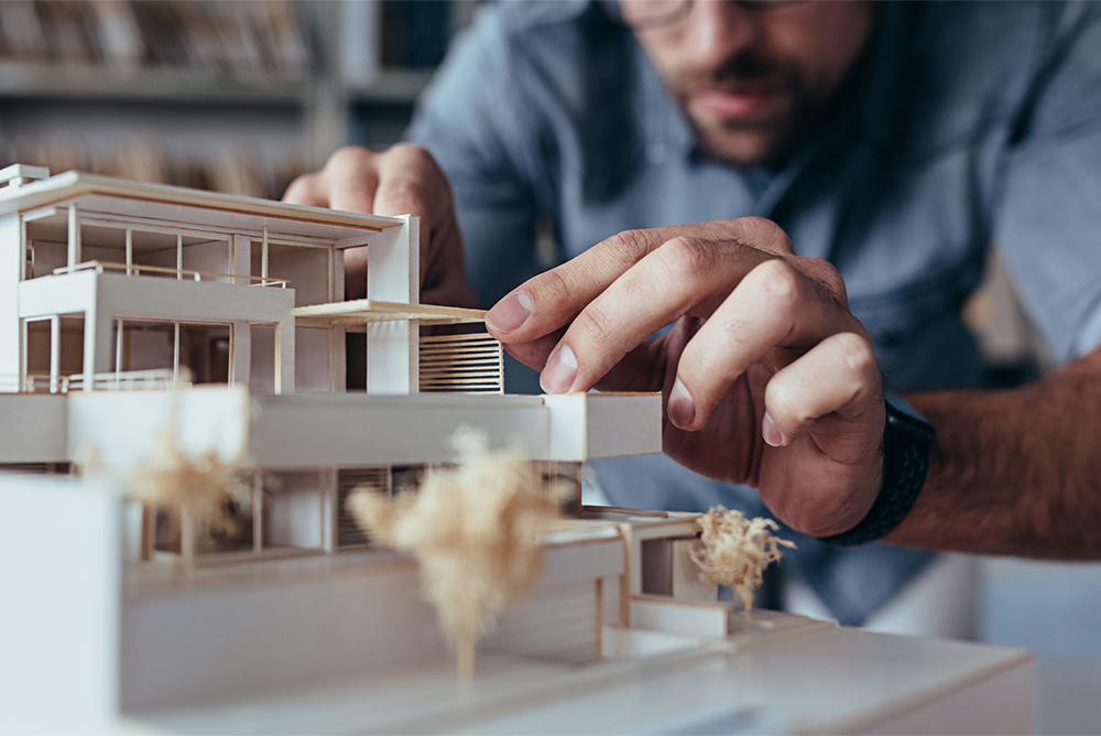 an architect builts a 3D model of a building